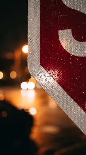 Wet Stop Sign Close-Up at Night