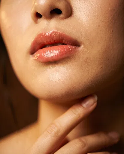 Extreme Close-Up of Coral Glossy Lips