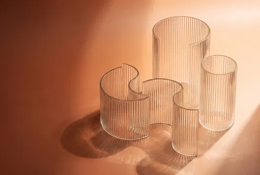 Fluted Glass Sculptures on Terracotta Background