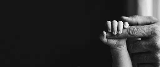 Newborn Hand Holding Father's Finger