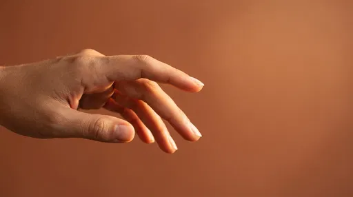 Hand Reaching Against Terracotta Background
