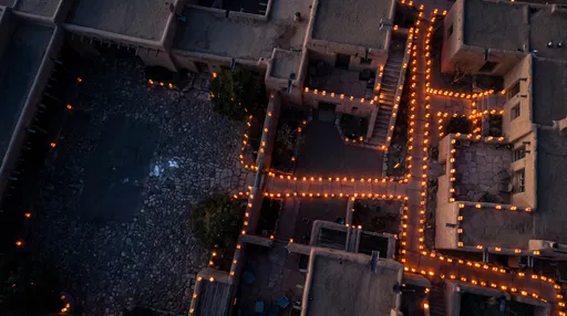Aerial Adobe Courtyard With Glowing Luminarias