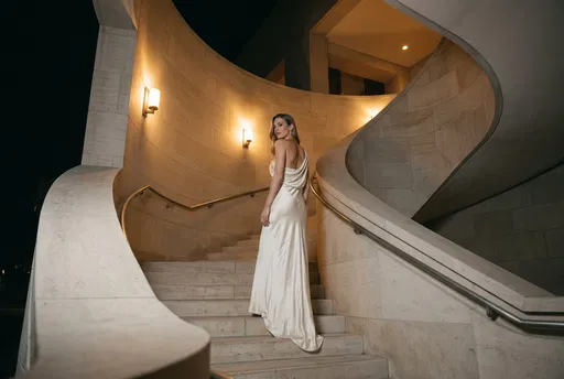 Woman in Silk Gown on Curved Staircase