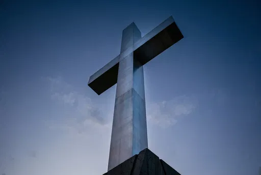 Brushed Steel Cross Against Twilight Sky