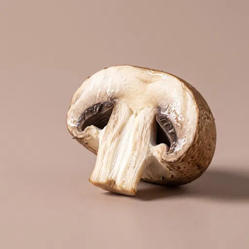 Halved Cremini Mushroom on Taupe Background