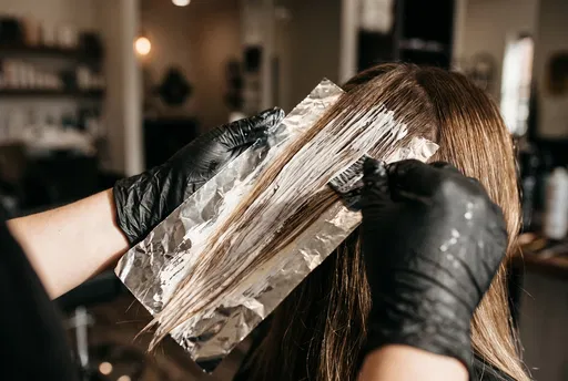 Stylist Applying Balayage Highlights on Foil