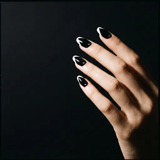 Hand With Black and White Geometric Nails