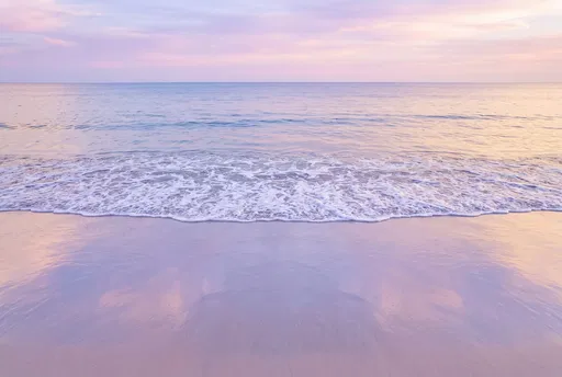 Pastel Sunset Over Calm Ocean Beach