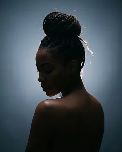 Backlit Studio Portrait of Woman with Braids