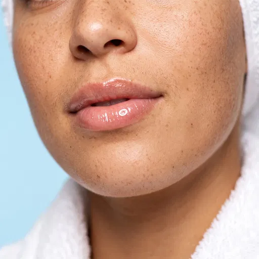 Close-Up of Freckled Woman With Glossy Lips