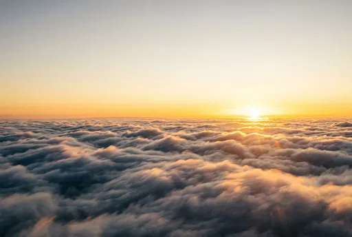 Golden Sunrise Above Sea of Clouds