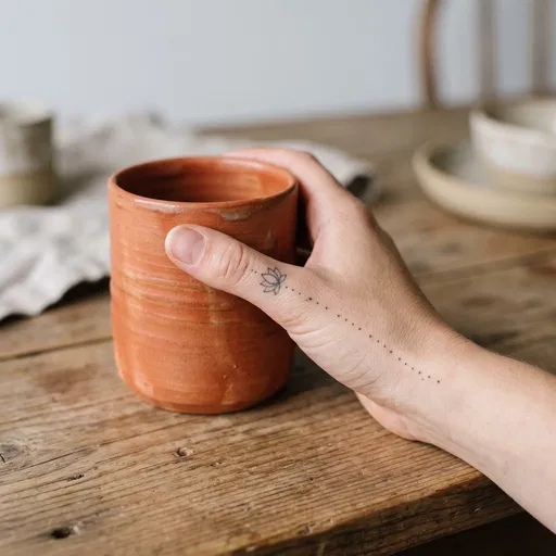 Hand With Lotus Tattoo Holding Mug
