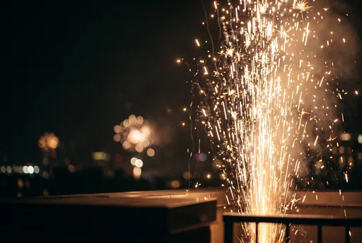 Golden Fountain Sparks on Night Rooftop