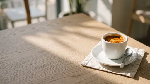 Espresso on Sunlit Wooden Cafe Table