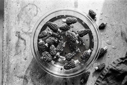 Morel Mushrooms Soaking in Glass Bowl