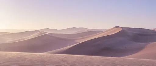Pastel Dawn Over Sweeping Desert Dunes