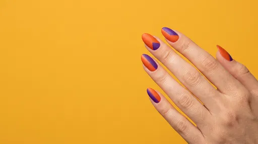 Manicured Hand With Orange Violet Nails