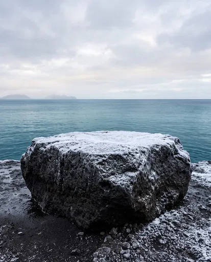 Snow Dusted Volcanic Rock Pedestal by Ocean