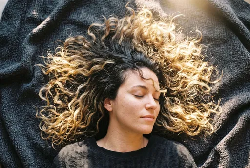 Woman With Curly Blonde Balayage Hair