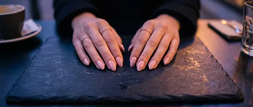 Woman's Hands With Light Pink Nails