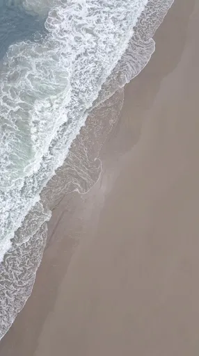 Aerial View of Ocean Waves on Sand
