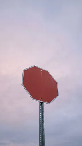 Blank Red Octagonal Sign Against Pastel Sky