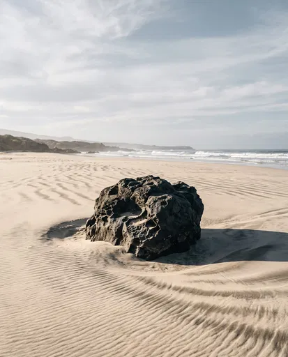 Volcanic Boulder on Rippled Sandy Beach
