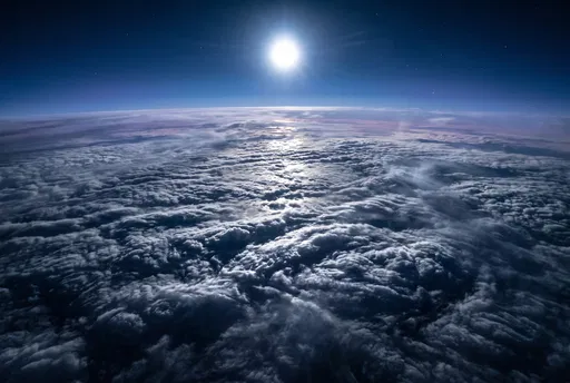 Bright Moon Over High Altitude Clouds
