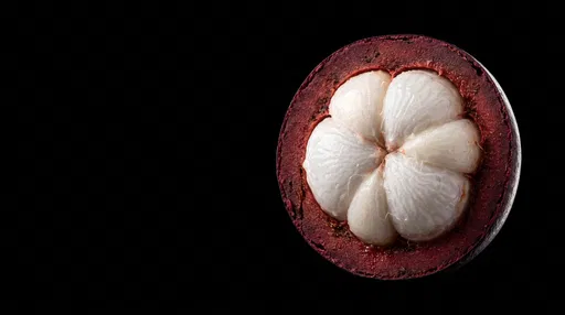 Halved Mangosteen on Black Background
