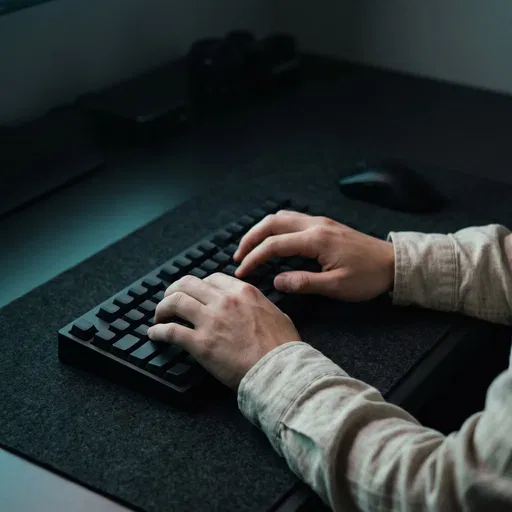 Hands Typing on Minimalist Black Keyboard