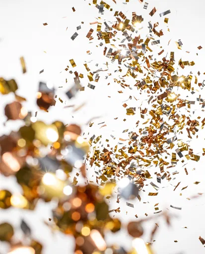 Swirling Metallic Confetti on White Background