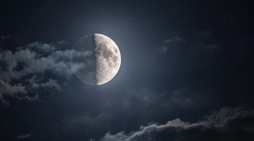 Quarter Moon Behind Night Sky Clouds