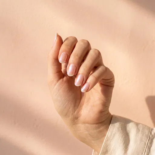 Hand With Pearlescent Pink Nail Art