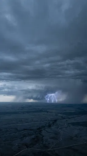 Distant Lightning Storm Over Dark Prairie