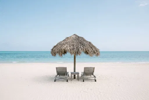 Thatched Umbrella and Loungers on Beach