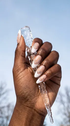 Hand With Winter Nail Art Holding Icicle