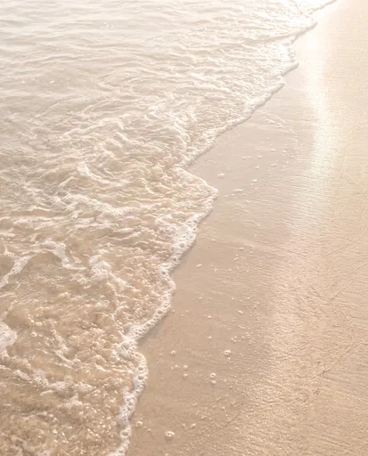 Gentle Foaming Waves on Champagne Sand