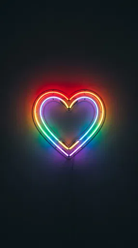 Glowing Rainbow Neon Heart on Dark Wall