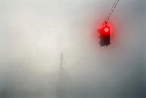 Glowing Red Traffic Light in Fog