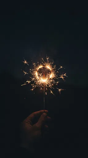 Hand Holding Lit Ring Sparkler at Night
