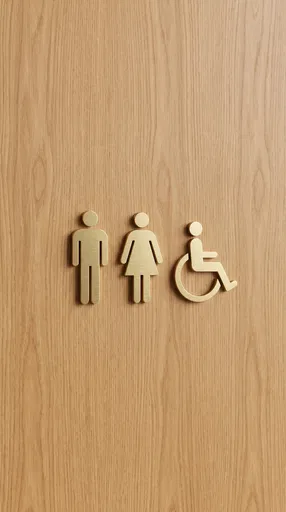 Brushed Brass Restroom Signs on Wood