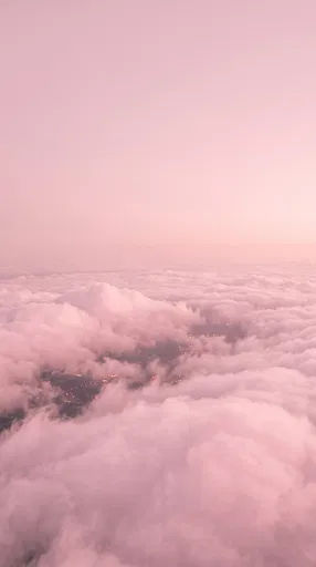Aerial View Over Soft Pink Clouds