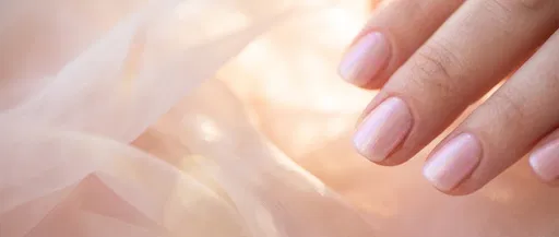 Close-Up of Pale Pink Iridescent Manicure
