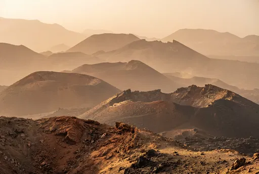 Layered Volcanic Cinder Cones in Golden Haze