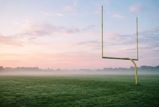 Yellow Football Goalpost on Misty Dawn Field
