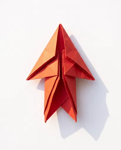 Red Origami Arrow on White Background