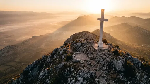 White Cross on Mountain Peak at Sunrise