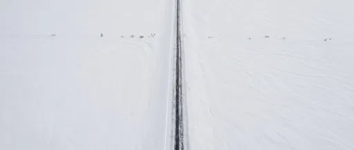 Minimalist Aerial View of Snowy Country Road