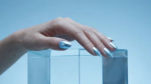 Hand With Blue Chrome Manicure on Pedestal