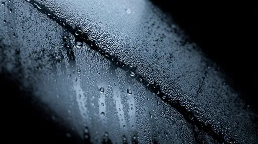 Cool Blue Condensation Droplets on Dark Glass
